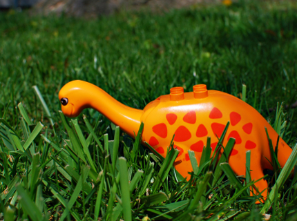 Toy Dinosaur in the Grass