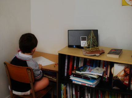 Little boy sitting at a desk coloring
